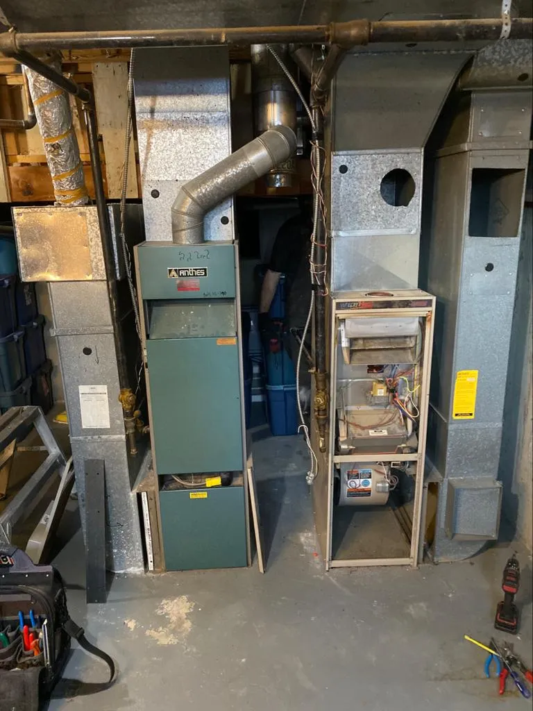 Older furnace and open ductwork in a greater Edmonton area basement before replacement